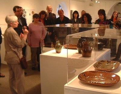Kathy Niblett giving the symposium delegates a private tour of the exhibition.